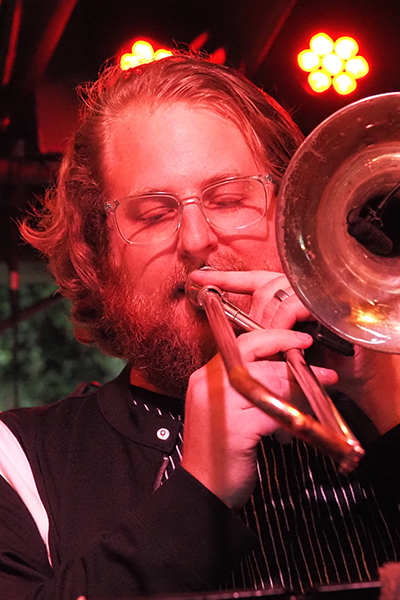 a headshot of Chad O'Brien playing trombone